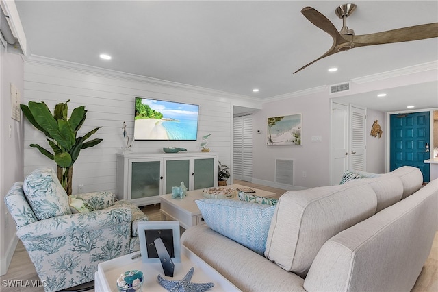 living room featuring recessed lighting, visible vents, crown molding, and light wood-style flooring