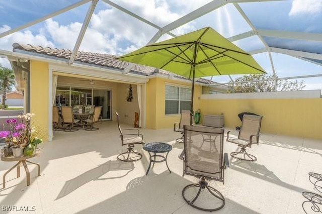 view of patio featuring a lanai