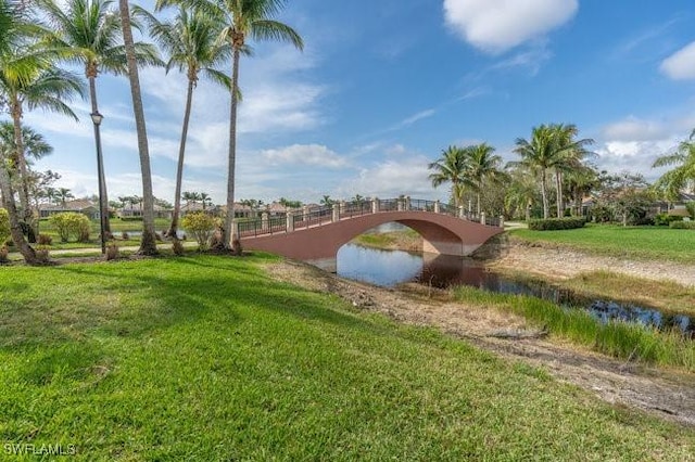 surrounding community featuring a water view and a yard