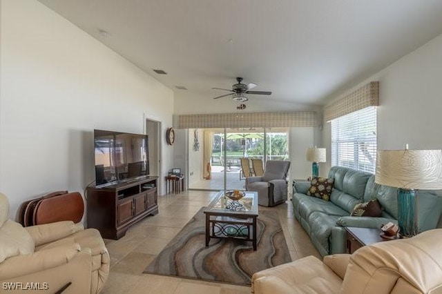 living area featuring light tile patterned floors, plenty of natural light, and a ceiling fan