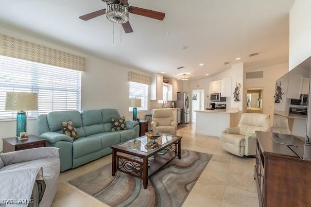 living area featuring vaulted ceiling, a ceiling fan, and light tile patterned flooring