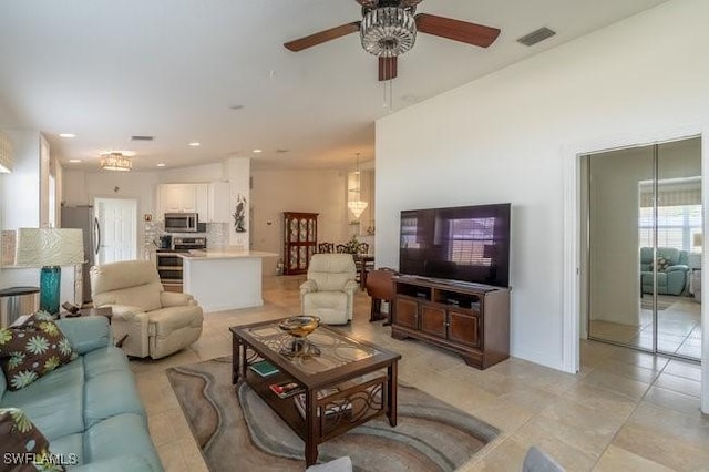 living room featuring light tile patterned floors, ceiling fan, visible vents, and recessed lighting