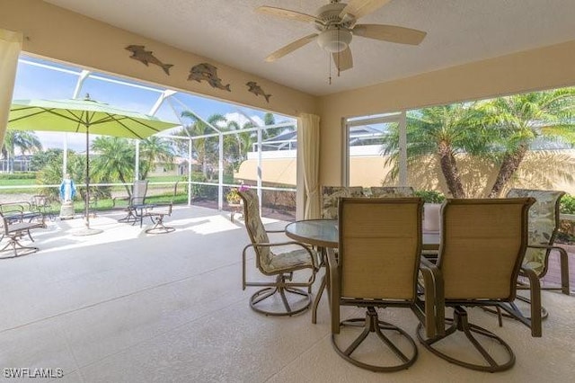 sunroom / solarium featuring ceiling fan