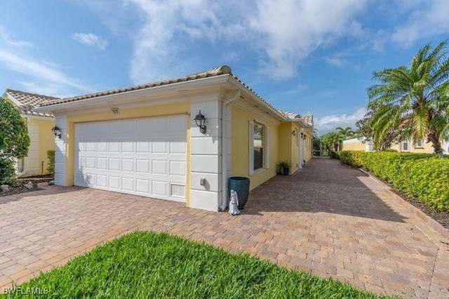 view of home's exterior with a garage and stucco siding