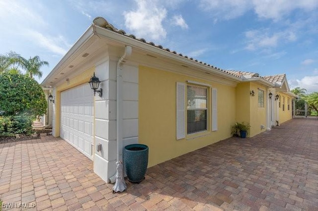 view of home's exterior featuring a garage and stucco siding