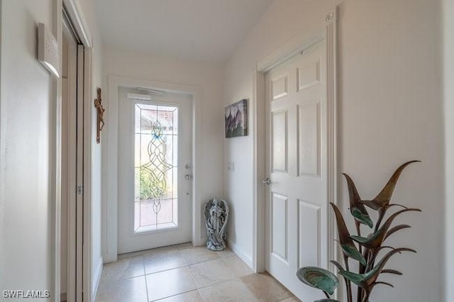 doorway to outside featuring light tile patterned floors