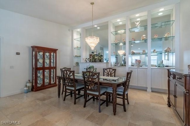 dining space with an inviting chandelier