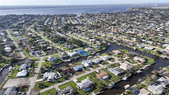 birds eye view of property featuring a water view and a residential view