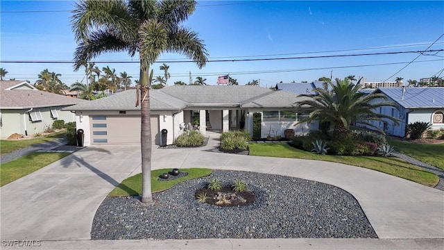 single story home featuring a garage, concrete driveway, roof with shingles, a front lawn, and stucco siding