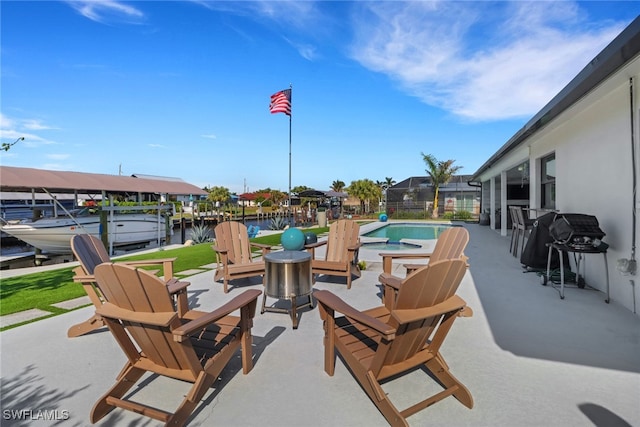 view of patio featuring a fenced in pool, boat lift, a water view, grilling area, and a boat dock