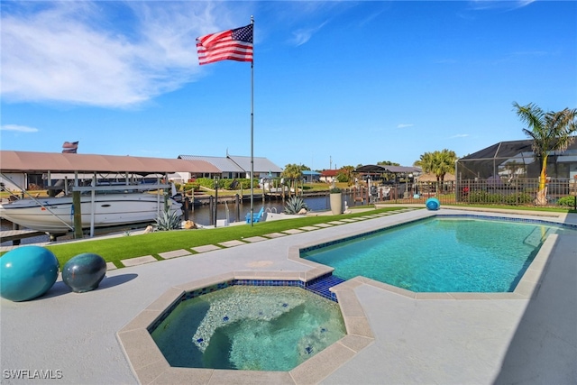 view of pool featuring a boat dock, boat lift, an in ground hot tub, a water view, and fence