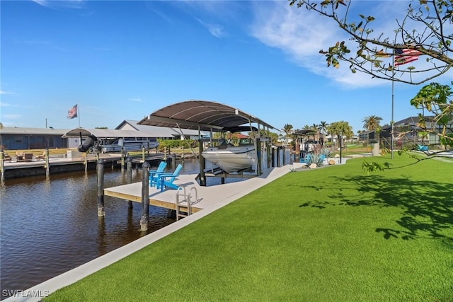 view of dock featuring a water view, a lawn, and boat lift