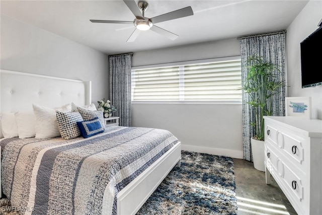 bedroom with ceiling fan, baseboards, and concrete flooring