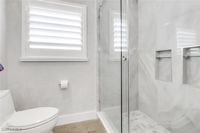 full bath featuring a stall shower, toilet, and baseboards