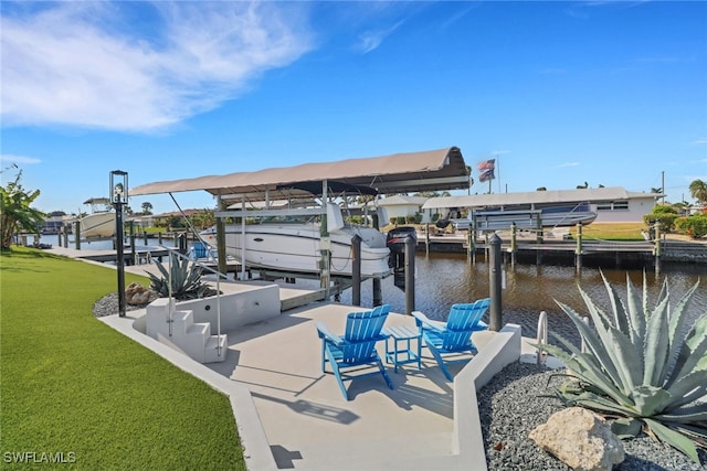 dock area featuring a water view, a yard, and boat lift