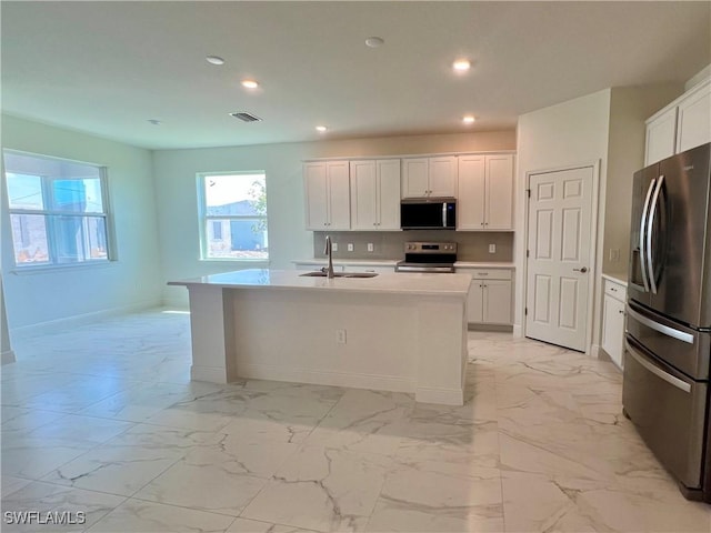 3511 NW 19th Ter, Cape Coral, FL 33909 - kitchen featuring appliances with stainless steel finishes, light marble finish flooring, a sink, recessed lighting, and white cabinets