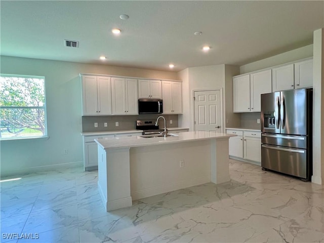 3511 NW 19th Ter, Cape Coral, FL 33909 - kitchen featuring stainless steel appliances, light marble finish floors, recessed lighting, an island with sink, and a sink