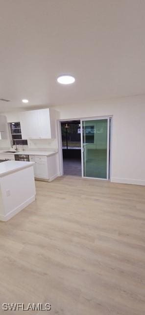 kitchen featuring light hardwood / wood-style floors and white cabinetry