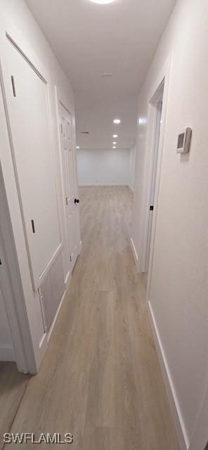 corridor with light hardwood / wood-style floors