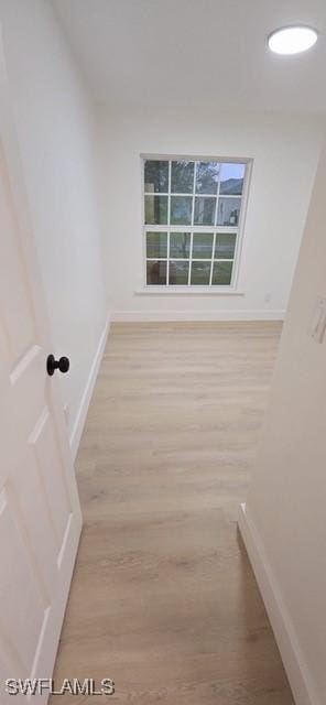 empty room with light hardwood / wood-style flooring