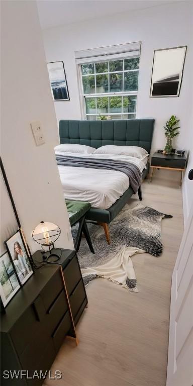 bedroom with wood-type flooring