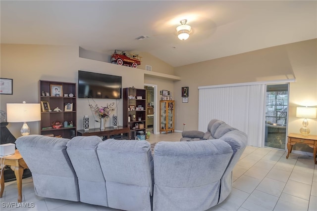 living room with light tile patterned floors and vaulted ceiling