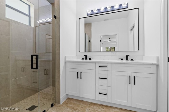 bathroom with vanity and a shower with door