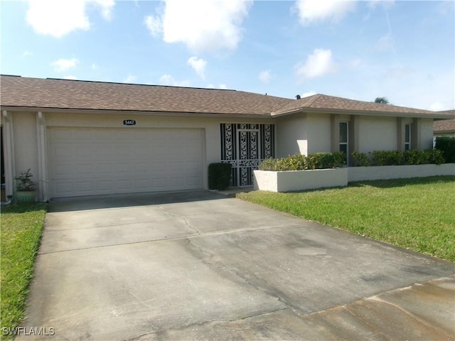 ranch-style house featuring a garage, driveway, a front lawn, and stucco siding