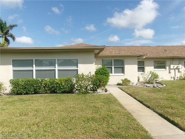 5447 Capbern Ct, Fort Myers, FL 33919 - view of front of property featuring roof with shingles, a front yard, and stucco siding