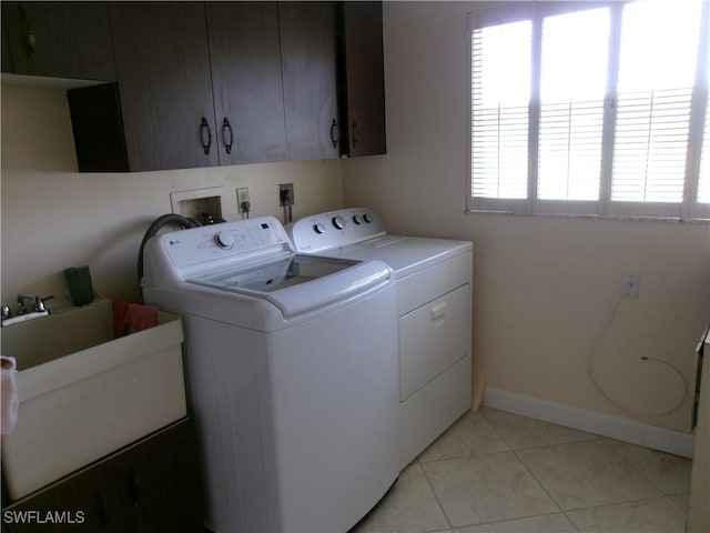 5447 Capbern Ct, Fort Myers, FL 33919 - laundry room with a sink, washing machine and clothes dryer, cabinet space, and baseboards