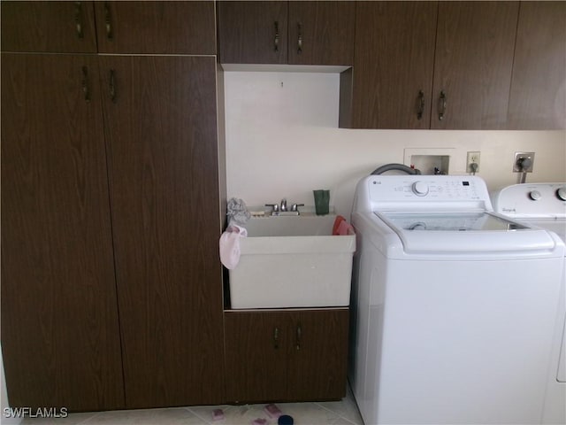 5447 Capbern Ct, Fort Myers, FL 33919 - washroom featuring light tile patterned floors, independent washer and dryer, a sink, and cabinet space