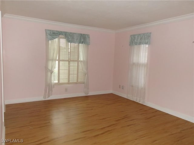 5447 Capbern Ct, Fort Myers, FL 33919 - empty room featuring crown molding, baseboards, and wood finished floors