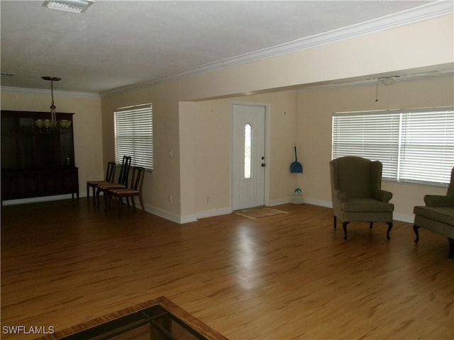 5447 Capbern Ct, Fort Myers, FL 33919 - entryway with baseboards, ornamental molding, wood finished floors, and a notable chandelier
