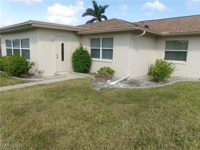 5447 Capbern Ct, Fort Myers, FL 33919 - exterior space with stucco siding, a shingled roof, and a front yard