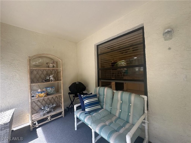 sitting room featuring a textured wall