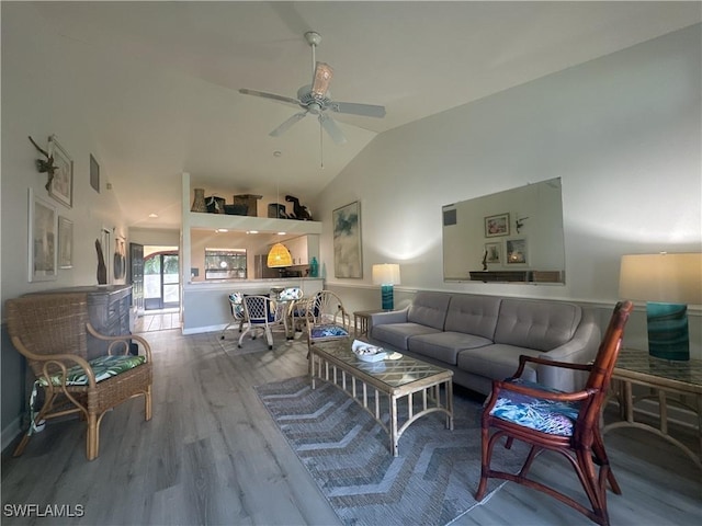 living area with high vaulted ceiling, wood finished floors, and a ceiling fan