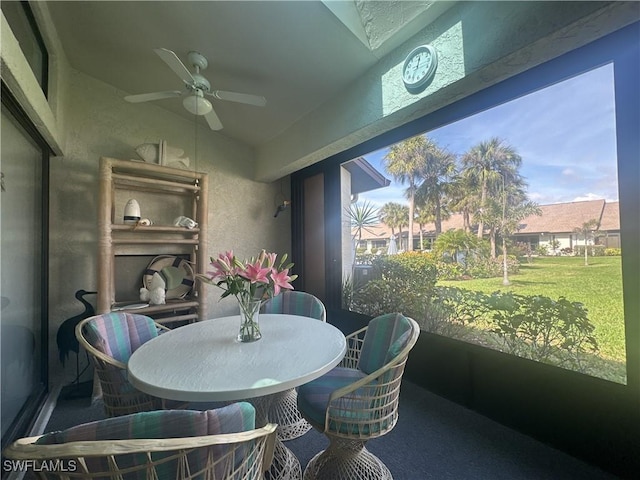 sunroom / solarium with ceiling fan and lofted ceiling