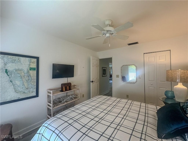 bedroom featuring baseboards, ceiling fan, visible vents, and a closet