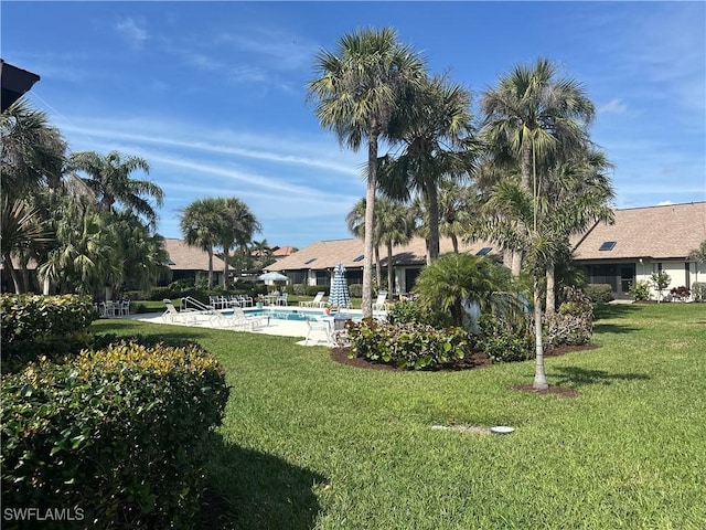 view of yard with a community pool and a patio