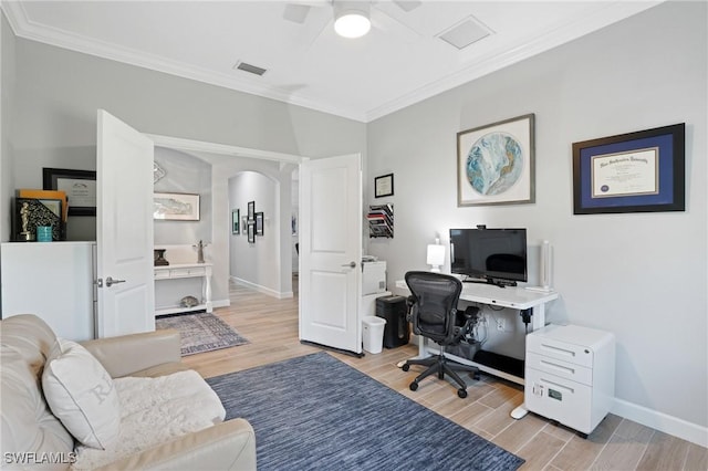 home office featuring visible vents, arched walkways, baseboards, ornamental molding, and wood tiled floor