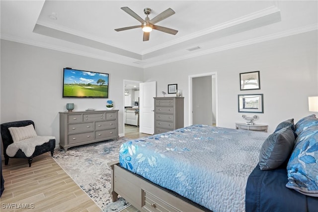 bedroom featuring ceiling fan, visible vents, light wood-type flooring, a raised ceiling, and crown molding