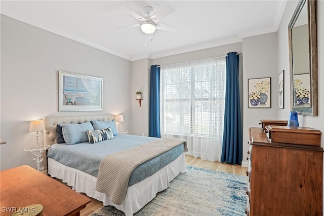 bedroom featuring ceiling fan, light wood-style flooring, and crown molding