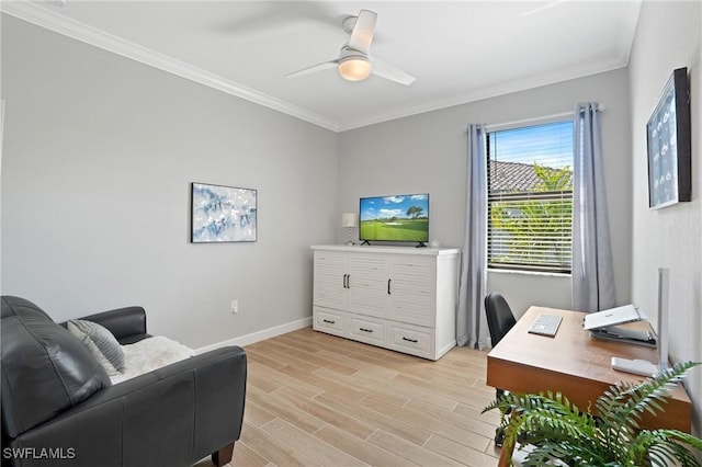 office area featuring ornamental molding, light wood-type flooring, baseboards, and a ceiling fan