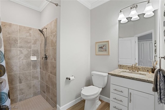 full bathroom featuring toilet, wood finished floors, vanity, tiled shower, and crown molding