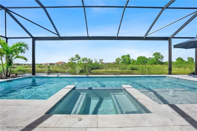 view of pool featuring a pool with connected hot tub, a patio, and a lanai