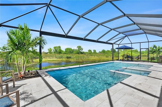 view of pool with a pool with connected hot tub, glass enclosure, a patio area, and a water view