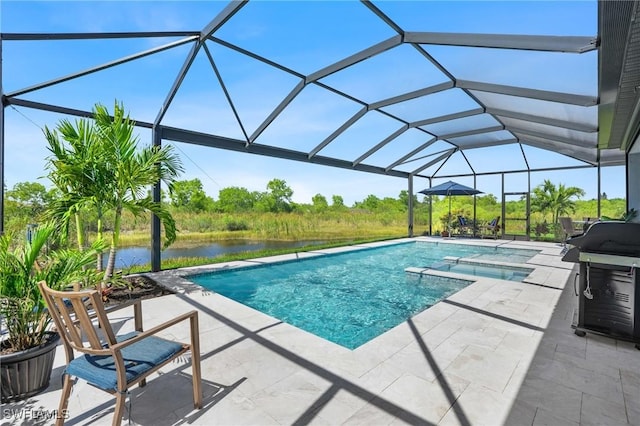 view of pool featuring a patio, glass enclosure, a water view, a grill, and a pool with connected hot tub