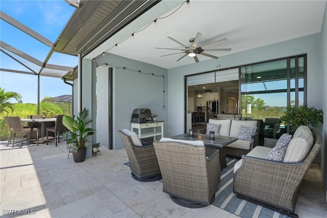 view of patio / terrace featuring glass enclosure, ceiling fan, an outdoor hangout area, and outdoor dining space