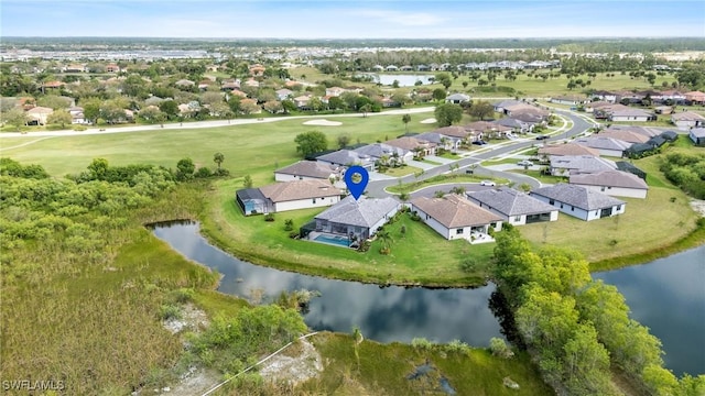 drone / aerial view with a water view and a residential view