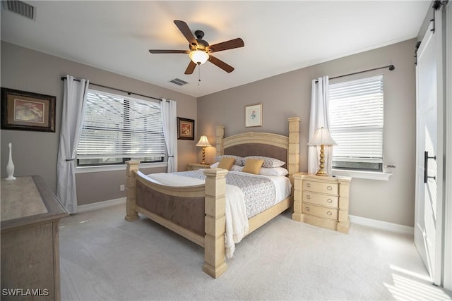 bedroom featuring visible vents, light carpet, and baseboards